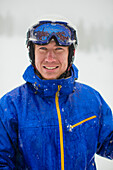 Caucasian man wearing ski gear in snow, Truckee, CA, USA