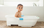 Mixed race boy having bath in tub, Lehi, Utah, USA