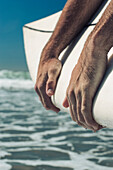 Close up of Caucasian man's hands, Venice Beach, CA, USA