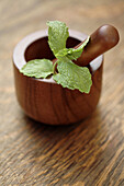 Close up of herbs in wooden mortar and pestle, Santa Fe, New Mexico, USA