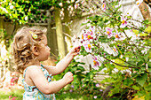 Caucasian girl in garden, Portland, OR, USA