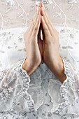 Mixed race bride's hands in prayer position, Halifax, Nova Scotia, Canada