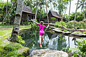 Caucasian girl swinging on rope in garden, Ubud, Bali, Indonesia, Ubud, Bali, Indonesia