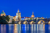 Charles Bridge and city illuminated at dusk, Prague, Czech Republic, Prague, Central Bohemia, Czech Republic