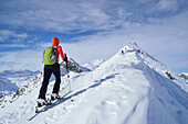 Female back-country skier ascending to Ellesspitze, Pflersch Valley, Stubai Alps, South Tyrol, Italy