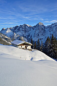 Snow-covered alpine hut in front of mountain scenery, Wilder Kaiser, Kaiser Mountains, Tyrol, Austria