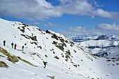 Back-country skiers downhill skiing from Schafsiedel, Kitzbuehel Alps, Tyrol, Austria