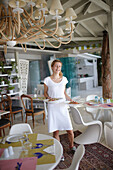 Waitress serving salads for lunch in a hotel restaurant, Vourvourou, Sithonia, Chalkidiki, Greece
