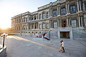 Couple strolling in the evening passing Ciragan Palace, Istanbul, Turkey