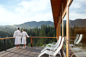 Couple on a balcony ouside a hotel sauna, Klais, Krun, Upper Bavaria, Germany