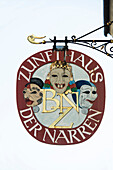 Sign with masks, historic center, Freiburg im Breisgau, Black Forest, Baden-Wuerttemberg, Germany