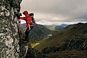 Frau beim Aufstieg zum Aonach Eagach, Glen Coe, Highlands, Schottland, Großbritannien