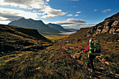 Woman walking to Shenavall Bothy, Letterewe Wilderness, Highlands, Scotland, Great Britain