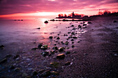 Stones and Buelk lighthouse in the morning light, Strande, Kiel Fjord, Schleswig-Holstein, Germany