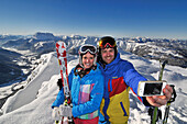 Couple photographing themselves, Steinplatte ski area, Waidring, Tyrol, Austria