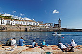 Boys fishing, Porthleven Harbour, Cornwall, England, Great Britain