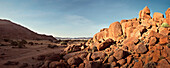 Panoramic view across red rocks towards the Tiras Mountains, Namib Naukluft National Park, Namibia, Africa
