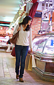 35 year old woman buying. Shopping at the Bretxa Market. Donostia. San Sebastian. Gipuzkoa. Basque Country. Spain.