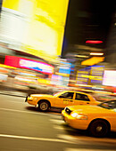 Taxicabs in motion, New York City, USA