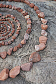 Brown rocks in a circle on grey rock