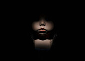Doll's face in darkness, close up