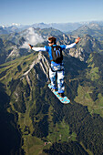 Man skysurfing over Saanen, Bern, Switzerland