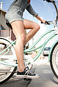Young woman riding bicycle