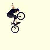 Young man on bmx bike, mid air