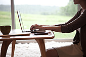 Woman sitting at table using laptop