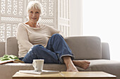 Senior woman relaxing on sofa at home