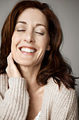 Happy and relaxed woman with closed eyes