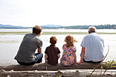 Children by river with father and grandfather