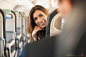 Female passenger turning around on aeroplane