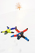 Two boys making snow angels