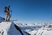 Man on skis at top of mountain in East Greenland