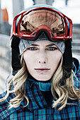 Young woman wearing skiwear and goggles