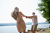 Young couple holding hands by lake
