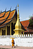 Young novice monks walk past Wat Sop in Luang Prabang, Laos.