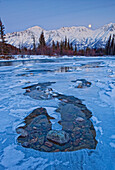 Moon And Ice Formations Along The Wheaton River, Yukon.