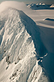 Strong Winds Sweep Snows Over A Peak On The Harding Ice Field In Kenai Fjords National Park, Southcentral Alaska, Winter