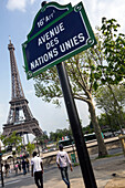 Road sign for avenue des nations unies (united nations avenue) in front of the eiffel tower, paris, 16th arrondissement, france