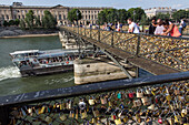 A stroll on the quays of the seine, pont des arts bridge covered in love padlocks, quay of the louvre, paris (75), france