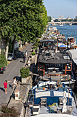 Houseboats moored along the banks of the seine (living on the water in the heart of paris), les tuileries quay, paris (75), france