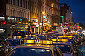 Taxi traffic jam on dame street at night, dublin, ireland