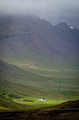 Isolated farm at the foot of the mountains, snaefellsnes peninsula, northwest iceland, europe