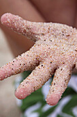 Child's Hand Covered in Sand