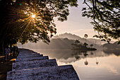 Sunrise at Kandy Lake and the island which houses the Royal Summer House, Kandy, UNESCO World Heritage Site, Central Province, Sri Lanka, Asia