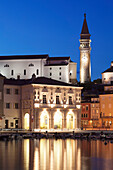 Waterfront buildings at the harbour and bell tower of Cathedral of St. George, Piran, Istria, Slovenia, Europe