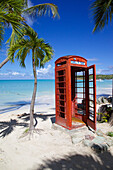 Beach and red telephone box, Dickenson Bay, St. Georges, Antigua, Leeward Islands, West Indies, Caribbean, Central America