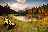 Bench in front of the Antorno Lake at sunset, Dolomites, Veneto, Italy